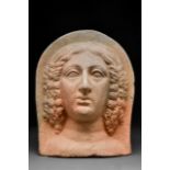 AN ETRUSCAN TERRACOTTA VOTIVE HEAD OF A WOMAN