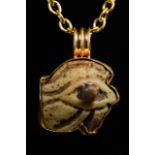 EGYPTIAN FAIENCE WEDJAT-EYE AMULET IN LATER GOLD PENDANT