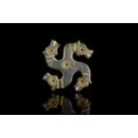 ROMAN BRONZE SWASTIKA BROOCH WITH HORSE HEADS