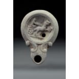 ROMAN TERRACOTTA OIL LAMP WITH CHARIOT SCENE AND MAKER'S MARK