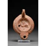 ROMAN TERRACOTTA OIL LAMP WITH DOLPHIN AND RUDDER