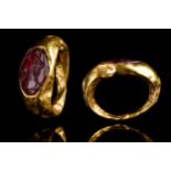 ROMAN GOLD RING WITH CARNELIAN INTAGLIO OF ARTEMIS AND A STAG