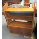 Oak open bookcase with three shelves over a blind panelled cupboard. 77cm wide approx. (B.P. 21% +