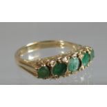 9ct gold five stone emerald ring. Ring size Q. Approx weight 4 grams. (B.P. 21% + VAT)