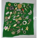 Collection of assorted vintage brooches of varying designs including flowers, foliage, Celtic
