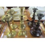 Three pairs of candlesticks, two brass, one with barley twist supports,m the other with palm tree