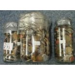 Three glass jars, containing assorted foreign coins. (B.P. 21% + VAT)