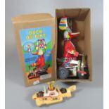 Modern tin plate clockwork duck on bike in original box, together with a Corgi Toys The Beetles