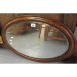 Mid Century simulated rosewood framed oval mirror with bevelled plate. (B.P. 21% + VAT)