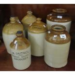 Collection of mainly stoneware flagons to include; Norton & Co Carmarthen, M Dutson herbal brewer