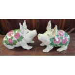 A pair of reproduction Wemyss style ceramic pigs, transfer printed with roses and foliage. Unmarked.