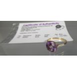 9ct gold amethyst dress ring, the fancy cut amethyst set to the centre with a diamnd. Stamped 10K.