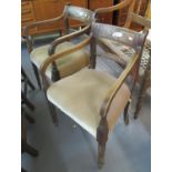 Two similar Regency mahogany open armed carver chairs with moulded bar backs, stuff over seats and