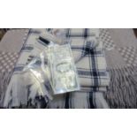 Three good quality woollen blankets; two matching with check and polka dot design and a cream and
