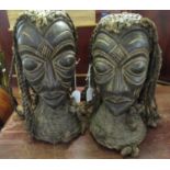 Pair of African carved wooden heads, probably male and female, both with plaited rope hair and