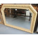 Modern cream and gilt framed over mantel mirror with upper canted angles and bevelled plate. (B.P.