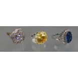 A silver gilt gemset ring, a yellow stone ring and a blue stone ring. Ring size O, Q and P. (B.P.