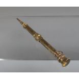 Yellow metal telescopic pencil set to the top with a citrine. (B.P. 21% + VAT)