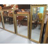 Group of three gilt framed rectangular mirrors, all foliate decorated, two with bevelled plates. (3)