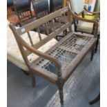 Early 20th Century pine two seater sofa or settle with spindle back, open arms with baluster