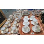 Set of six china cabinet cups and saucer with stylised foliate decoration and gilded mounts and