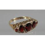 9ct gold five stone garnet ring. Ring size Q. Approx weight 3.5 grams. (B.P. 21% + VAT)