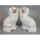 Pair of Staffordshire fireside seated spaniels with painted features. (2) (B.P. 21% + VAT)