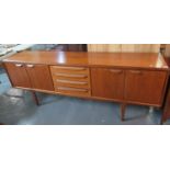 1970's G Plan style teak long sideboard with two pairs of blind panelled cupboards flanking four