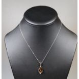 A silver and amber pendant on chain. (B.P. 21% + VAT)