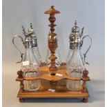 Late 19th century five bottle cruet stand, the matching cut glass bottles all with unmarked white