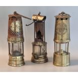Group of three miner's safety lamp to include an unused Protector Lamp and Lighting co. ltd, a