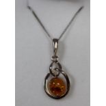 Silver and amber pendant on chain. (B.P. 21% + VAT)