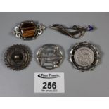 Three silver brooches and two white metal brooches including Victorian stamped brooch and a Rennie