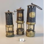 Three vintage used brass miner's safety lamps to include two by Thomas & Williams ltd. of Aberdare