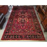 Modern Iranian red ground rug, overall with stylised flowers and foliage. 260 x 158cm approx.2 60