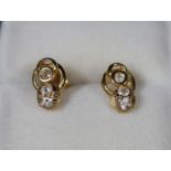 A Pair of yellow metal earrings set with white stones. Approx weight 2.6 grams. (B.P. 21% + VAT)