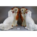 Two pairs of Staffordshire fire side dogs, one pair with glass eyes and painted features. (4) (B.