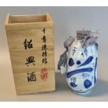 A bottle of 'Pagoda brand, 10 years aged superior, Shao Hsing Chiew' rice wine in a blue and white