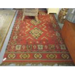 Red ground Kelim rug, overall with multicoloured geometric designs, 160 x 245cm approx. (B.P.