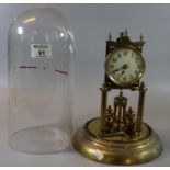 Early 20th Century brass perpetual motion clock, architectural design, with key and glass dome. (B.