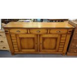 Modern oak sideboard, the moulded top above and arrangement of three drawers, with two blind panel
