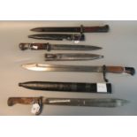 A group of four bayonets to include; two similar German First World War period bayonets and