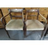 Two similar Regency mahogany open arm carver chairs with moulded bar backs, stuff over seats and