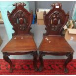 Pair of Victorian mahogany shield back hall chairs, having moulded decoration, moulded seat,