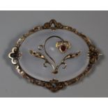 Victorian chalcedony brooch inset with a scrolling flower motif set with garnets and seed pearls. (