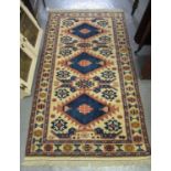 Turkish cream ground runner, overall with multicoloured lozenge and other geometric decoration.