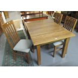 Modern oak dining table on square legs together with four matching oak slat backed, upholstered