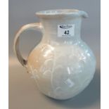 Early 20th Century glazed terracotta pottery baluster shaped loop handled jug with slip ware foliate