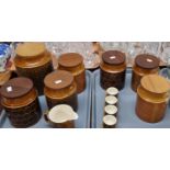 Two trays of various Hornsea pottery lidded storage jars, the lids made of different woods (7),