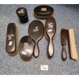 Box of ebony and white metal mounted vanity set with initials to include hand mirror, brushes,
